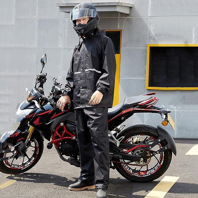 The adult electric motorbike raincoat man is wearing an outdoor rain-resilient waterproof raincoat and pants.