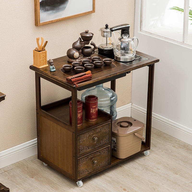 A small tea table with a tea kettle and a cupboard stand in the tea room for the tea truck.